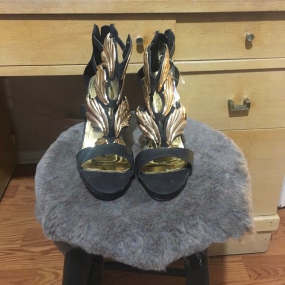 Black heels with gold emblems